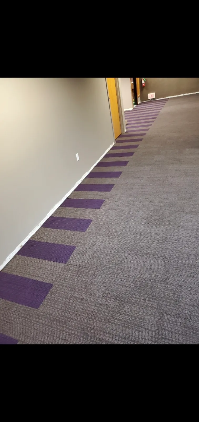 Commercial carpet tile in a hallway, installed by Threshing Floors